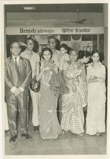 Black and white photograph of Preeti Mathur (first row, center left) at Bombay Airport in April 1978 with family on the eve of her departure to the United States. Used with the permission of Preeti Mathur.